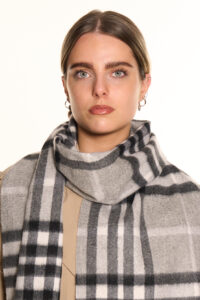 A grey cashmere scarf neatly folded in an elegant gift box.