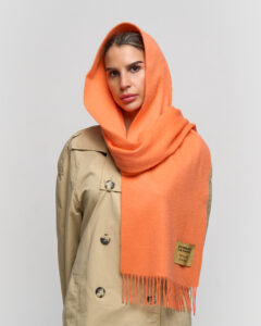 A mother wearing a luxurious cashmere scarf, showing elegance and warmth.