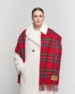Classic tartan and solid scarves displayed to show heritage craftsmanship