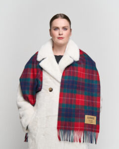 A group of friends draped in vibrant Scott Cashmere capes and scarves.
